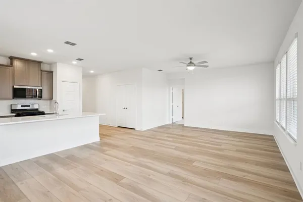 a view of kitchen with sink and wooden floor