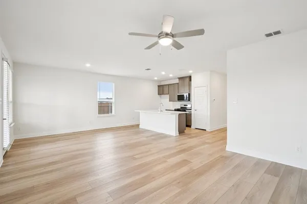 a view of kitchen with granite countertop cabinets and wooden floor