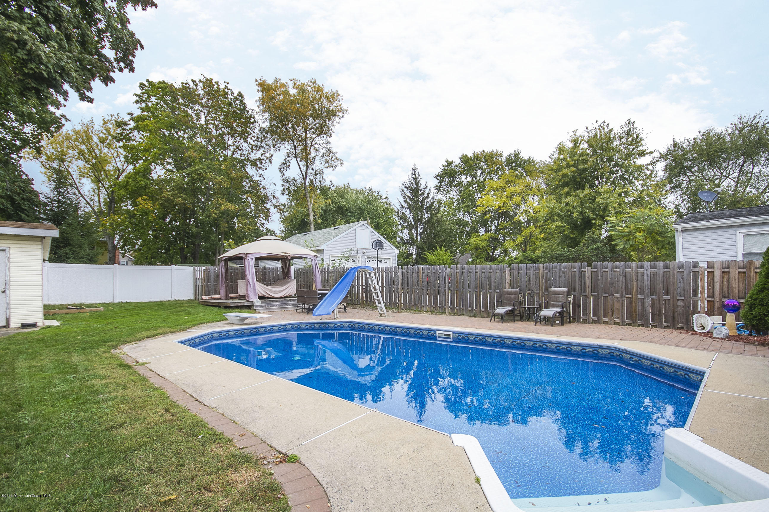 a view of a wooden deck and backyard