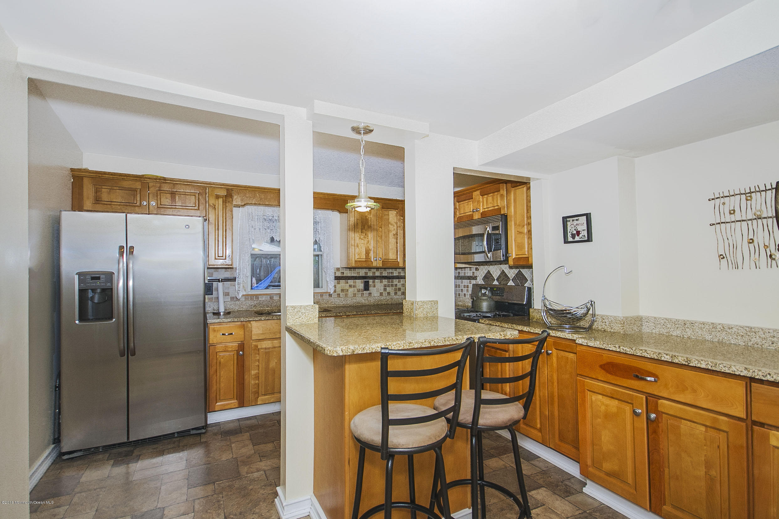 272 Main Street Matawan, NJ 07747 - Photo 13 of 36 a kitchen with stainless steel appliances granite countertop a refrigerator a sink a stove and island with wooden floor