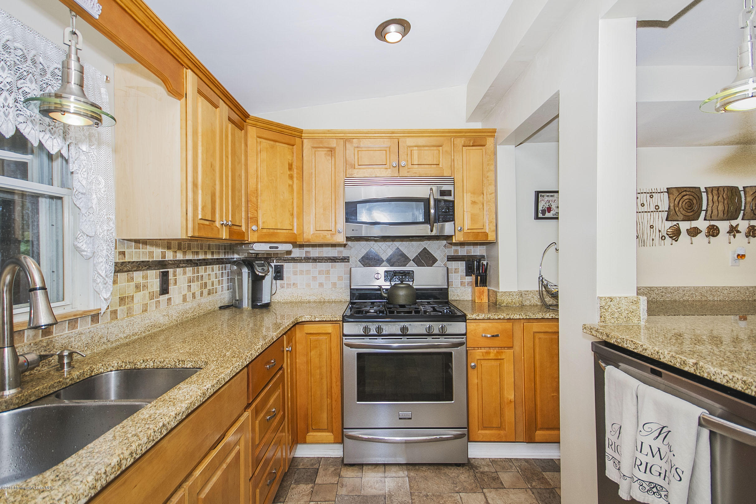 272 Main Street Matawan, NJ 07747 - Photo 14 of 36 a kitchen with stainless steel appliances granite countertop a stove a sink and a microwave