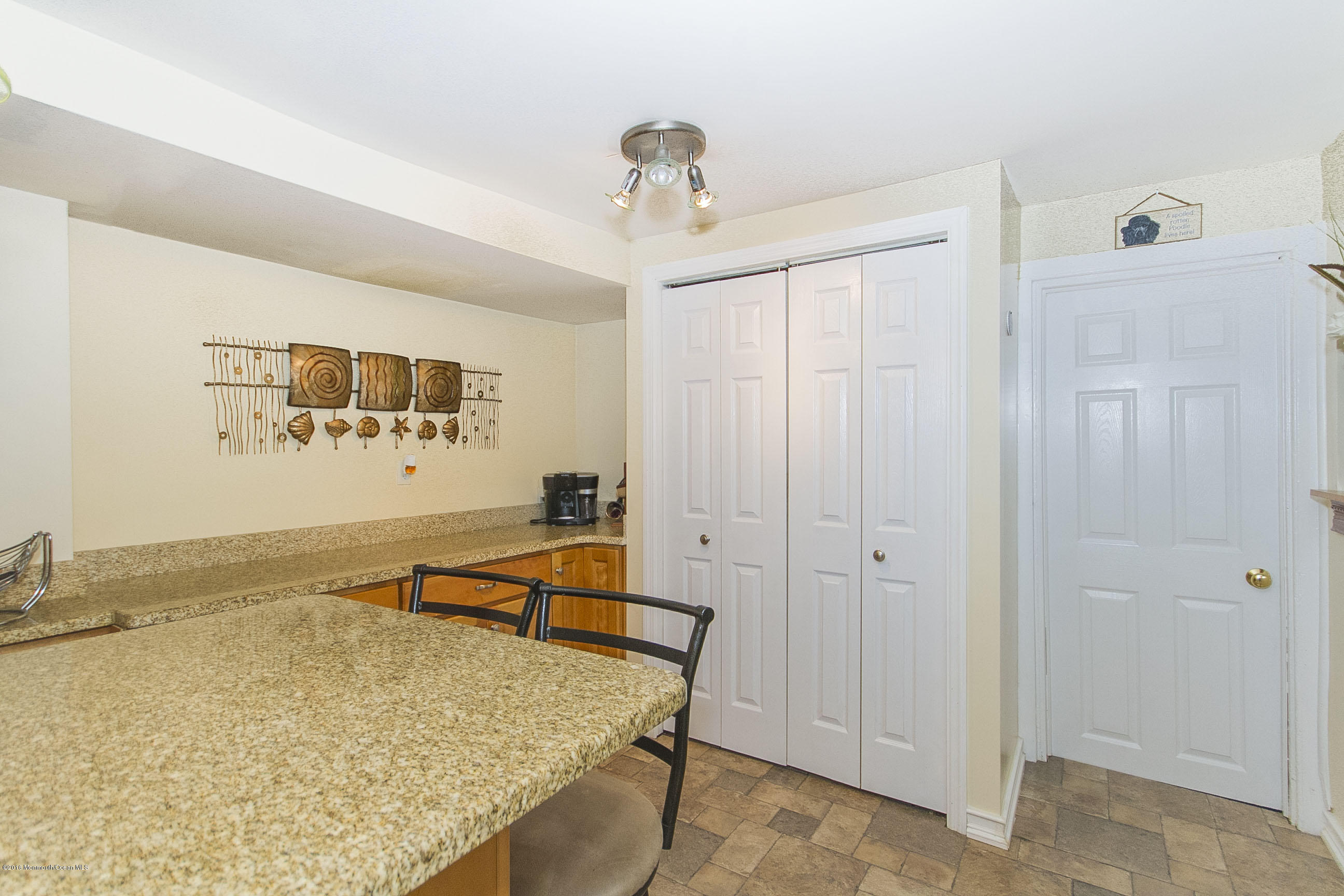 272 Main Street Matawan, NJ 07747 - Photo 16 of 36 a dining room with wooden floor and a chandelier