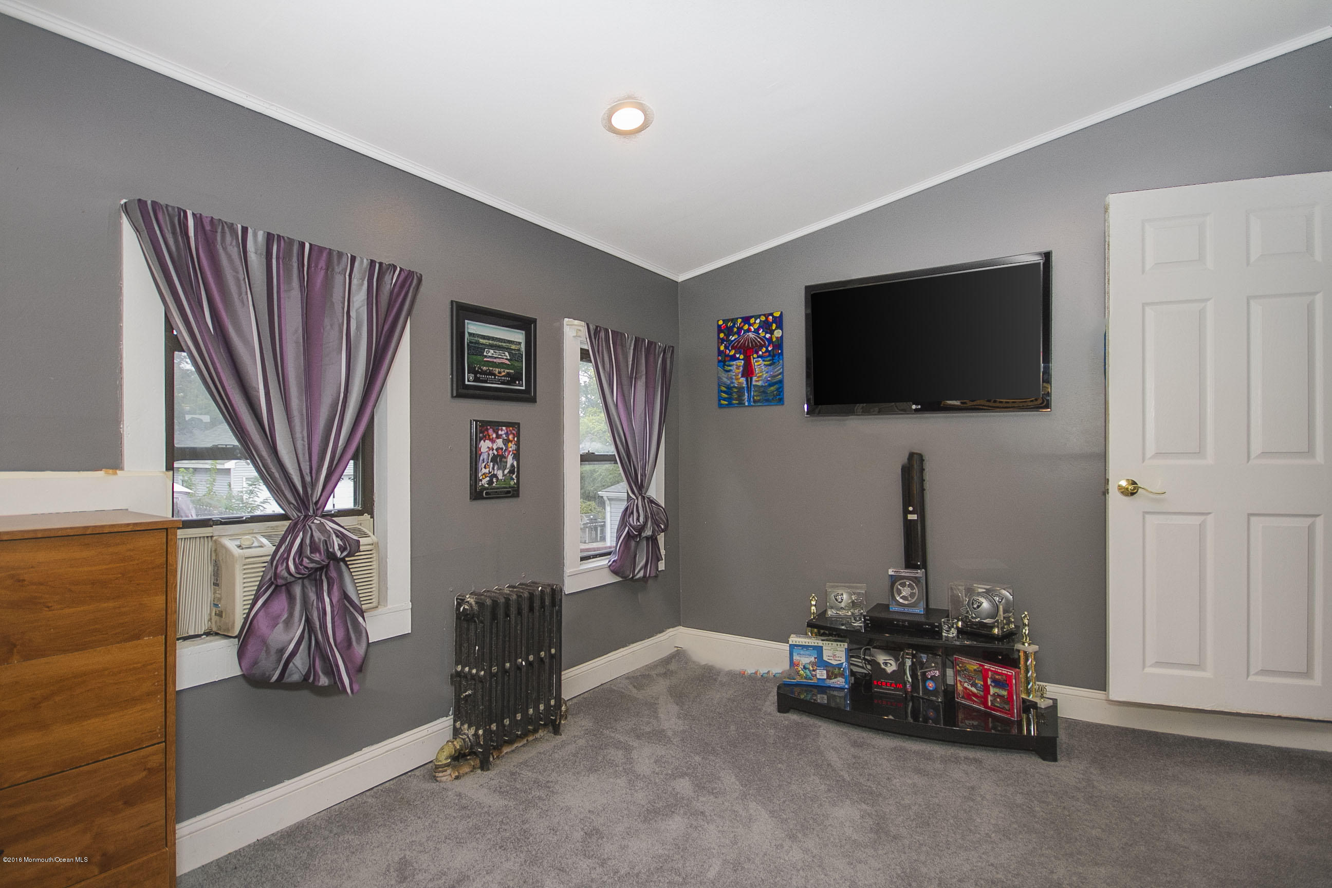 272 Main Street Matawan, NJ 07747 - Photo 26 of 36 a living room with furniture and a flat screen tv
