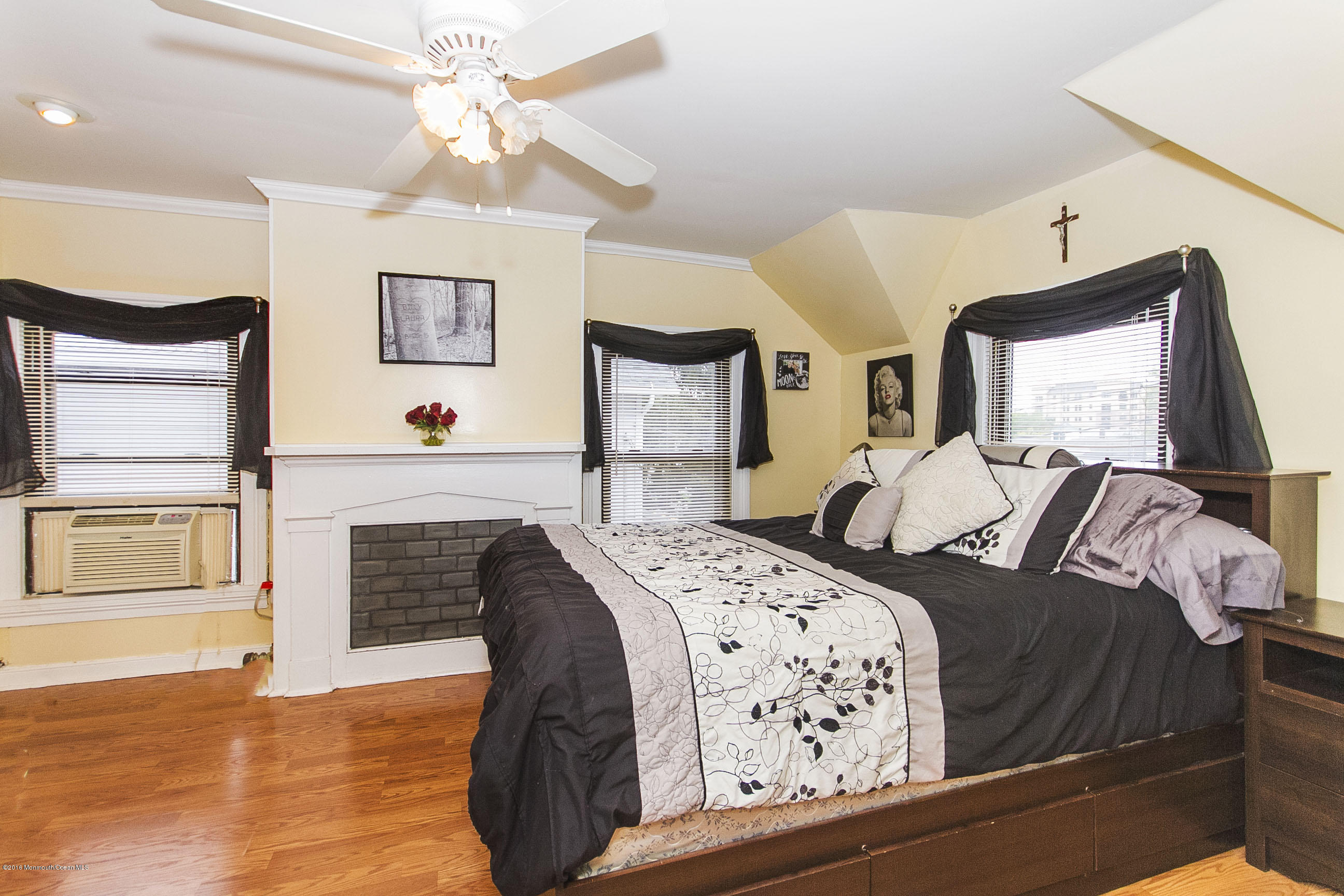 272 Main Street Matawan, NJ 07747 - Photo 31 of 36 a bedroom with a large bed and a fireplace