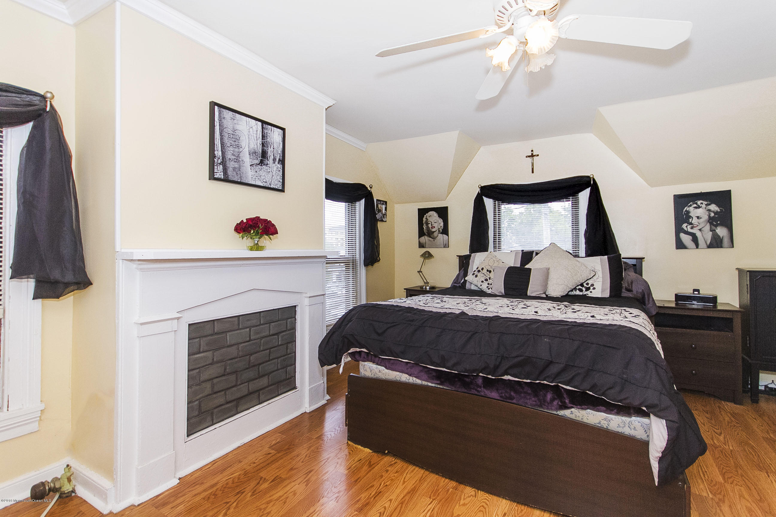 272 Main Street Matawan, NJ 07747 - Photo 32 of 36 a spacious bedroom with a bed and a fireplace