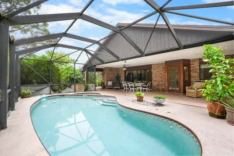 a view of swimming pool with outdoor seating