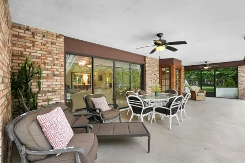 a dining room with furniture a chandelier and a rug
