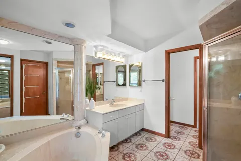 a bathroom with a double vanity sink mirror and shower