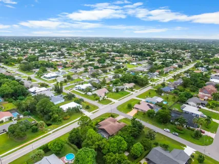an aerial view of residential houses with outdoor space and street view