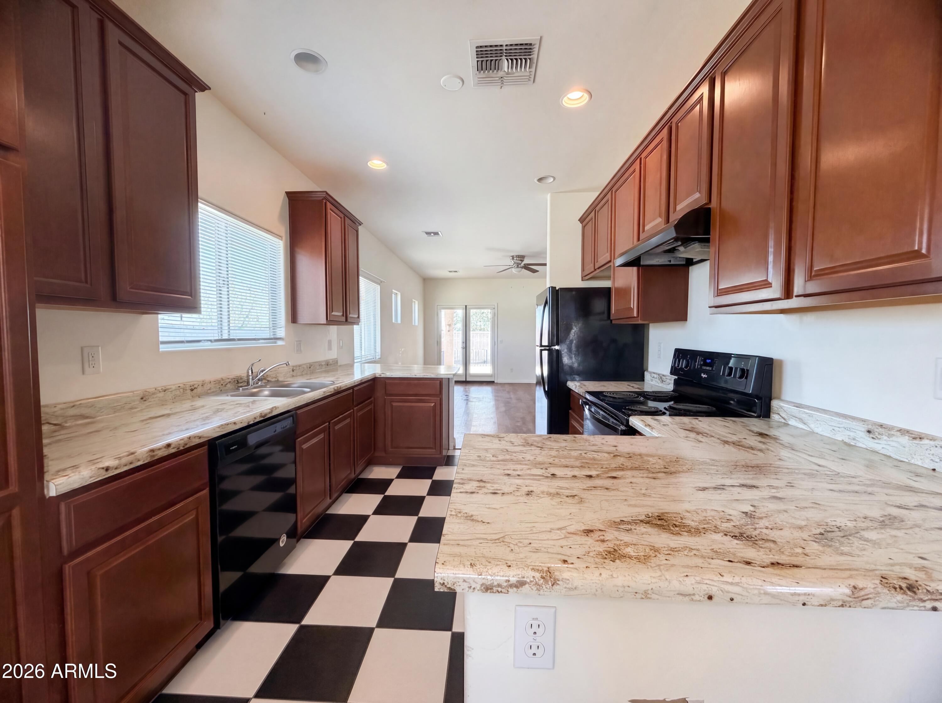 1738 South Aryelle Road Apache Junction, AZ 85119 - Photo 2 of 17 a kitchen with stainless steel appliances kitchen island granite countertop a sink and cabinets