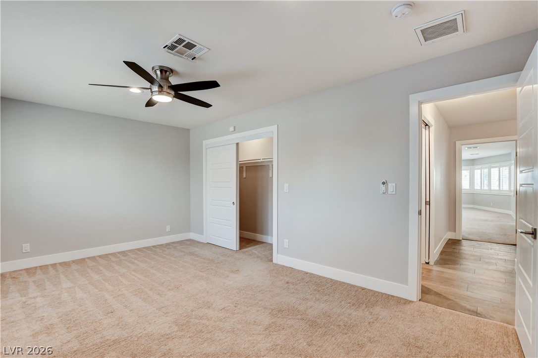 4207 Ridgecrest Drive Las Vegas, NV 89121 - Photo 21 of 27 Bedroom featuring light colored carpet, a spacious closet, and ceiling fan