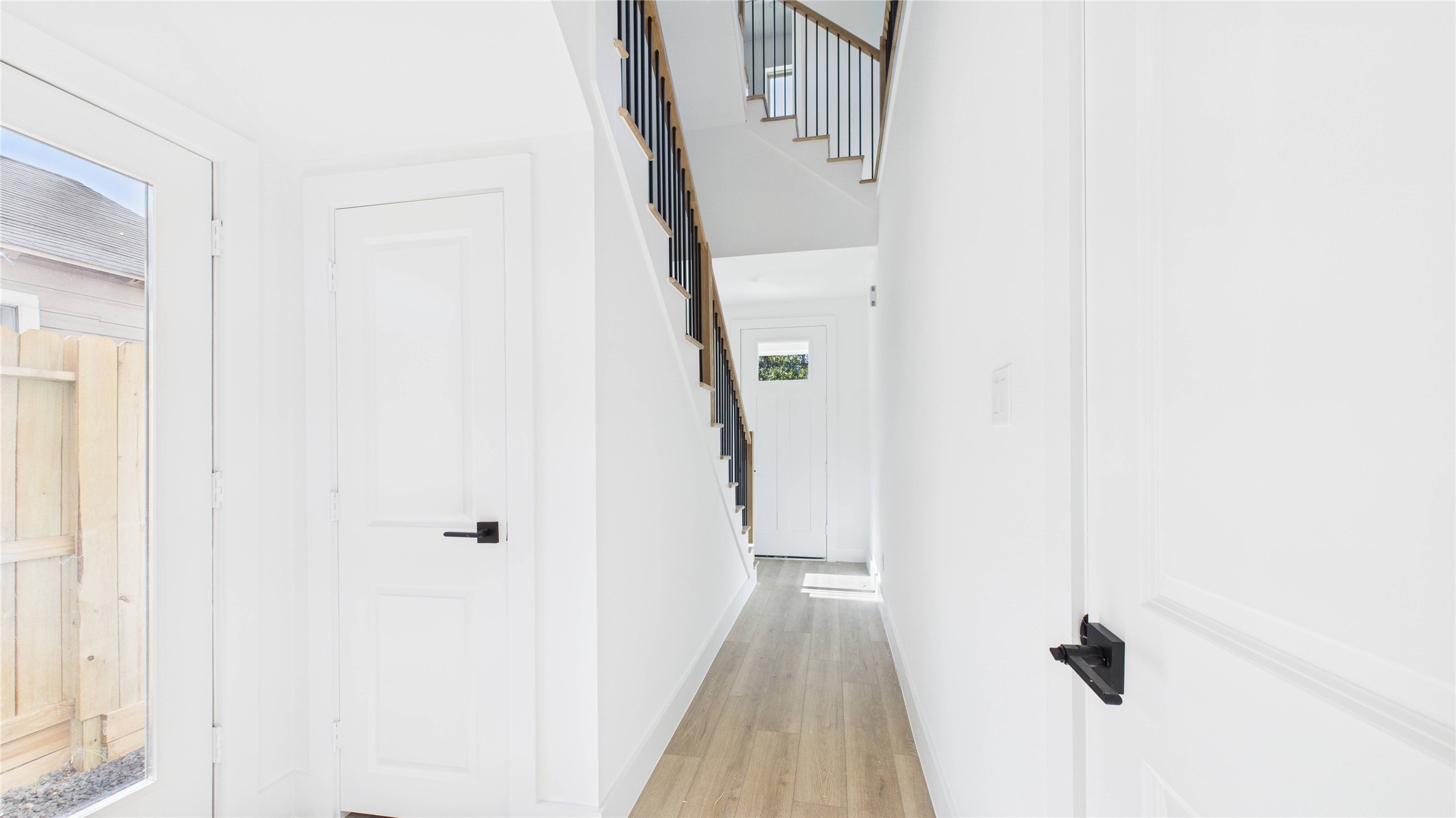 5318 Terry Street Houston, TX 77009 - Photo 4 of 28 a view of a hallway with wooden floor and staircase