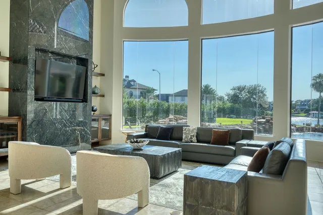 a view of an outdoor living room with furniture and a floor to ceiling window