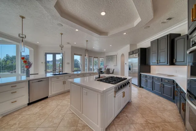 a kitchen with stainless steel appliances granite countertop a stove and a sink