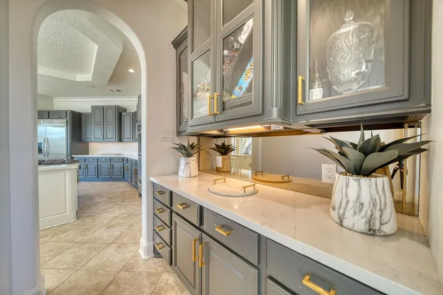 a bedroom with a bed window and a chandelier