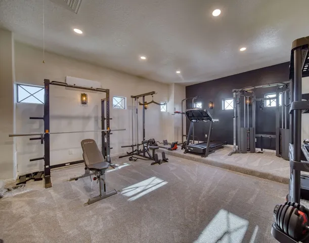 a bathroom with a granite countertop tub shower and mirror