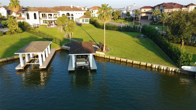 an aerial view of residential houses with outdoor space and ocean view
