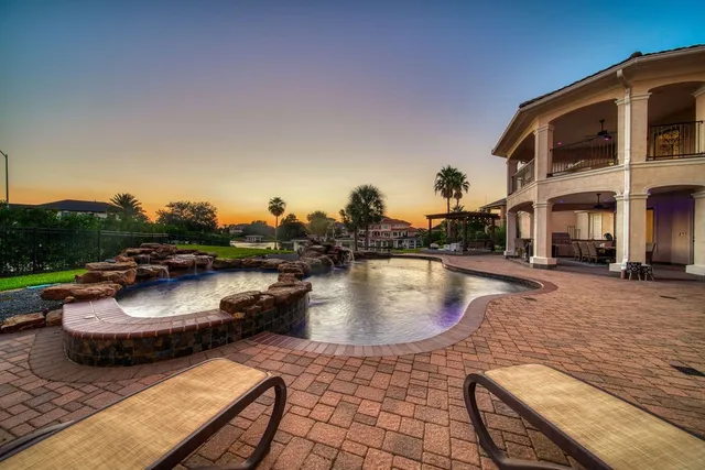 a view of a house with pool and trees