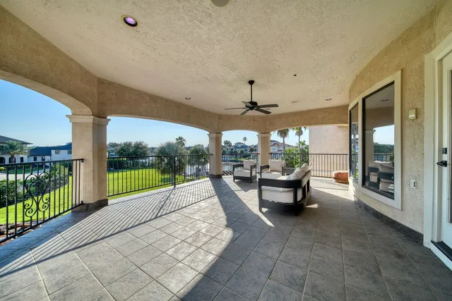 a view of a patio with a dining table chairs and a couple of potted plants