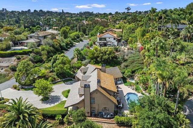 an aerial view of a house with a yard and sitting area