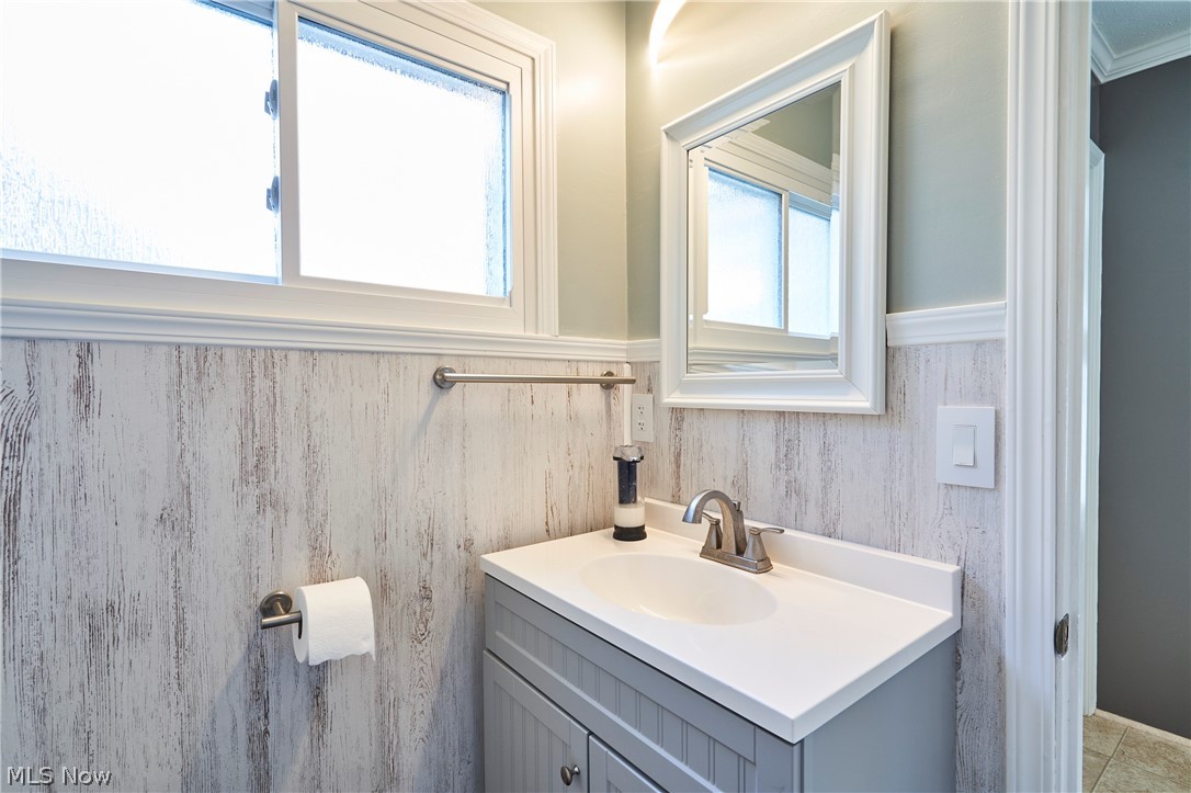 28322 Forest Road Willowick, OH 44095 - Photo 26 of 32 Bathroom featuring plenty of natural light, ornamental molding, tile flooring, and large vanity
