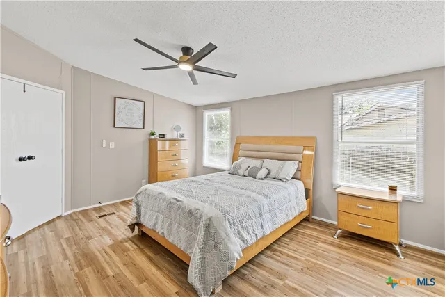 a bedroom with a large bed and a chandelier