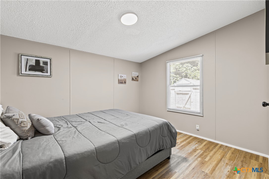 113 Austin Street Gatesville, TX 76528 - Photo 19 of 24 a bedroom with a bed and a window