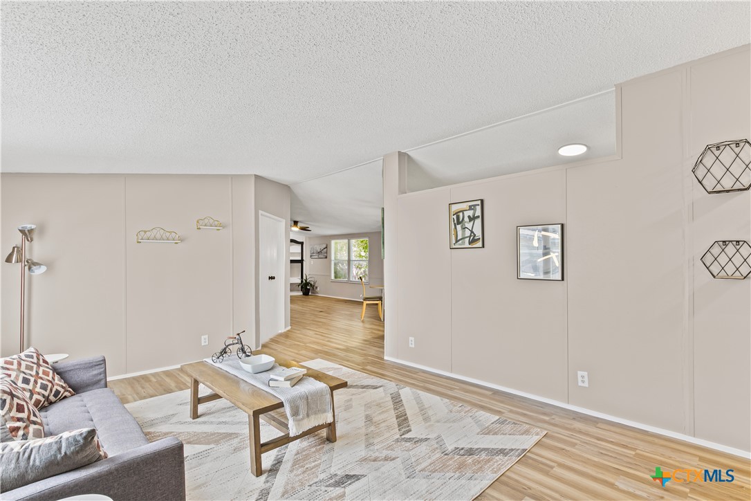 113 Austin Street Gatesville, TX 76528 - Photo 4 of 24 a living room with furniture and wooden floor