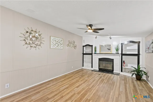 wooden floor in an empty room with a fireplace
