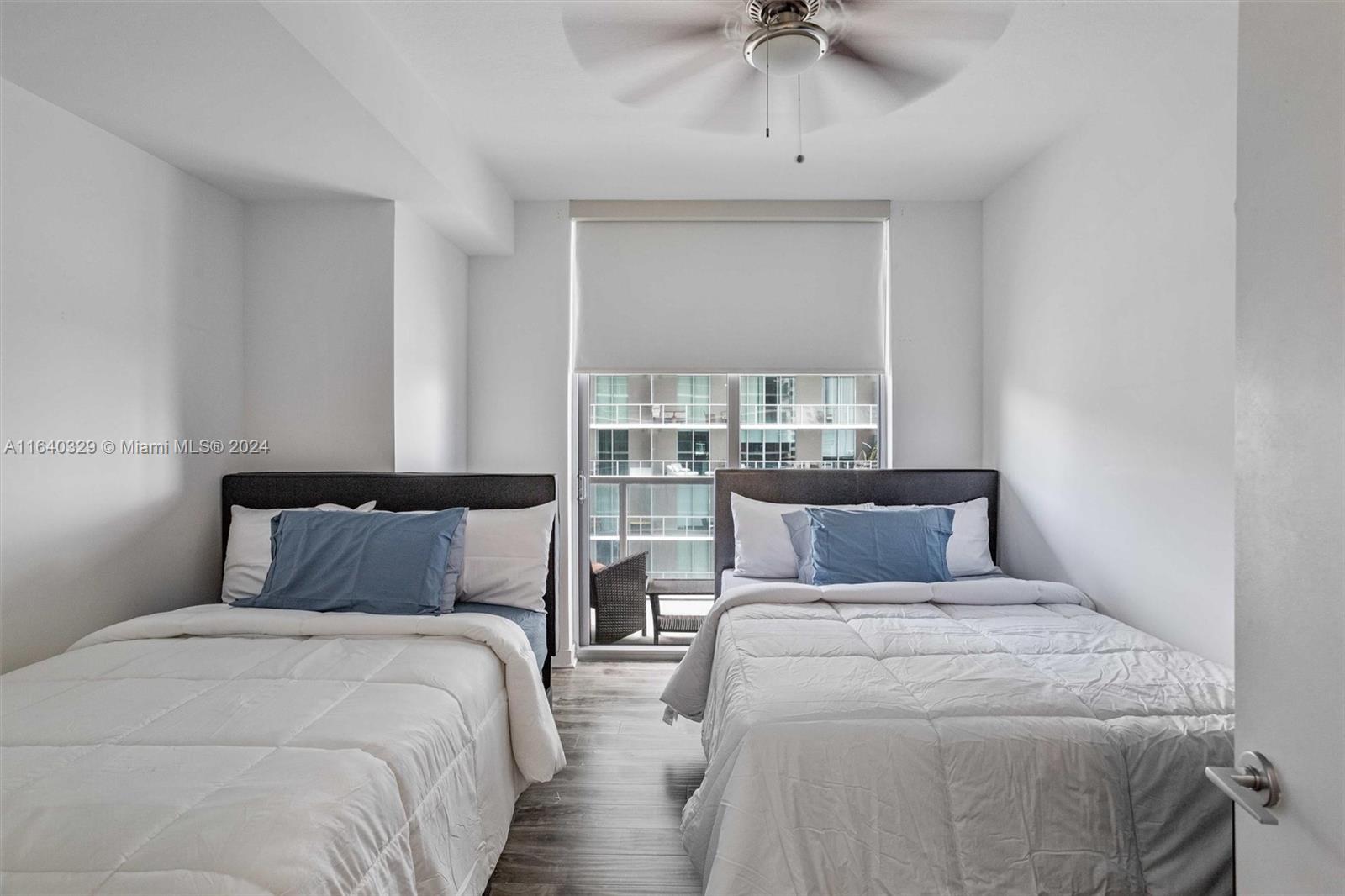 1111 Southwest 1st Avenue, Unit 3014N Miami, FL 33130 - Photo 11 of 36 a bedroom with a large bed and a chandelier