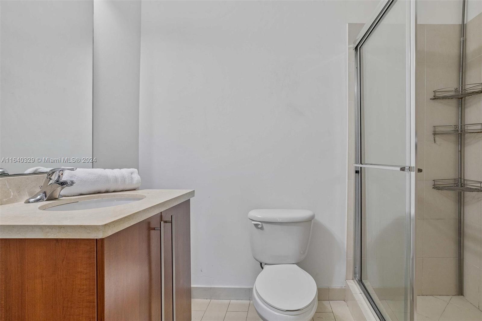 1111 Southwest 1st Avenue, Unit 3014N Miami, FL 33130 - Photo 14 of 36 a bathroom with a sink a toilet and shower