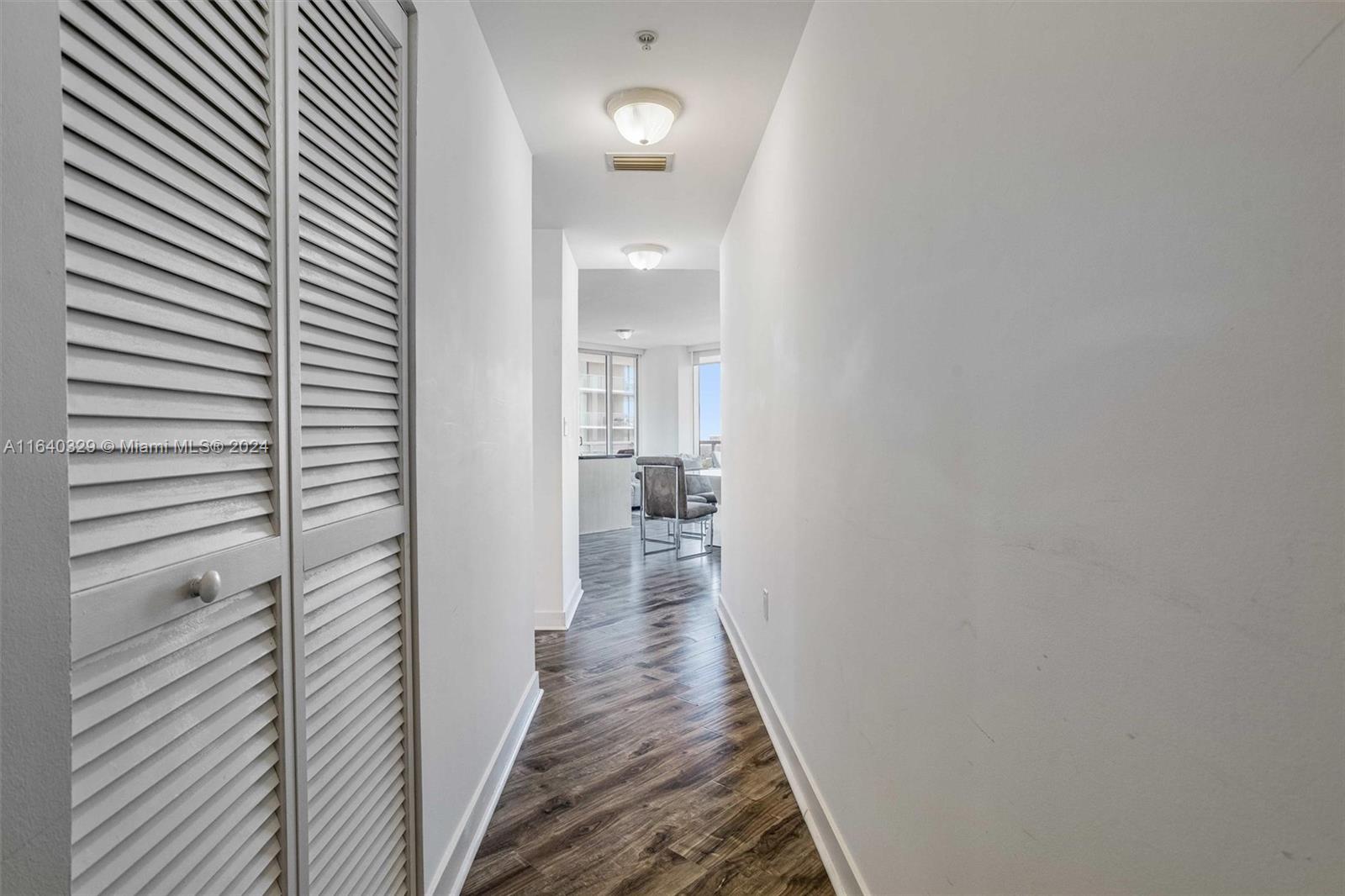 1111 Southwest 1st Avenue, Unit 3014N Miami, FL 33130 - Photo 15 of 36 a view of a hallway with wooden floor and closet