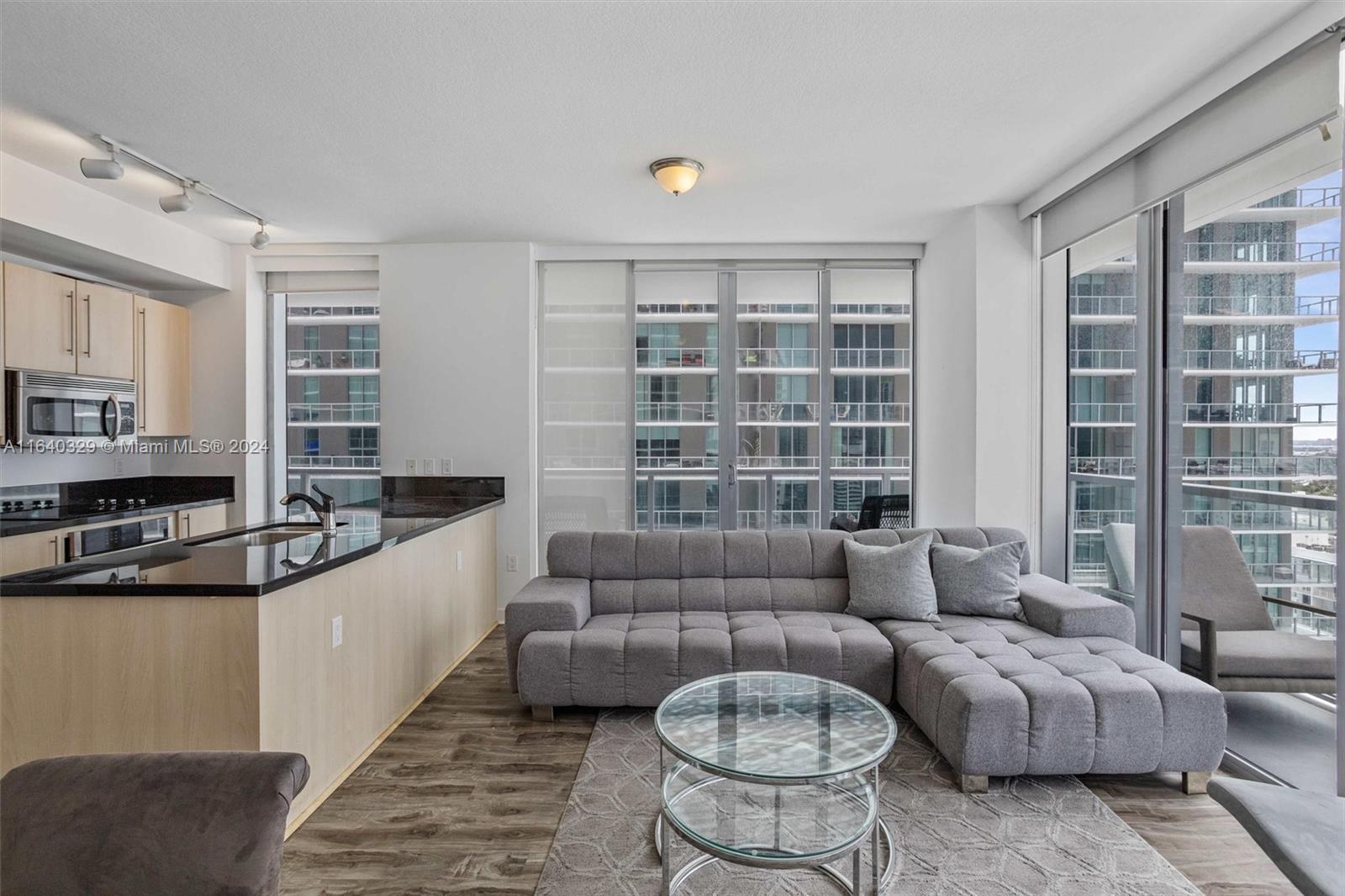 1111 Southwest 1st Avenue, Unit 3014N Miami, FL 33130 - Photo 6 of 36 a living room with furniture and a large window