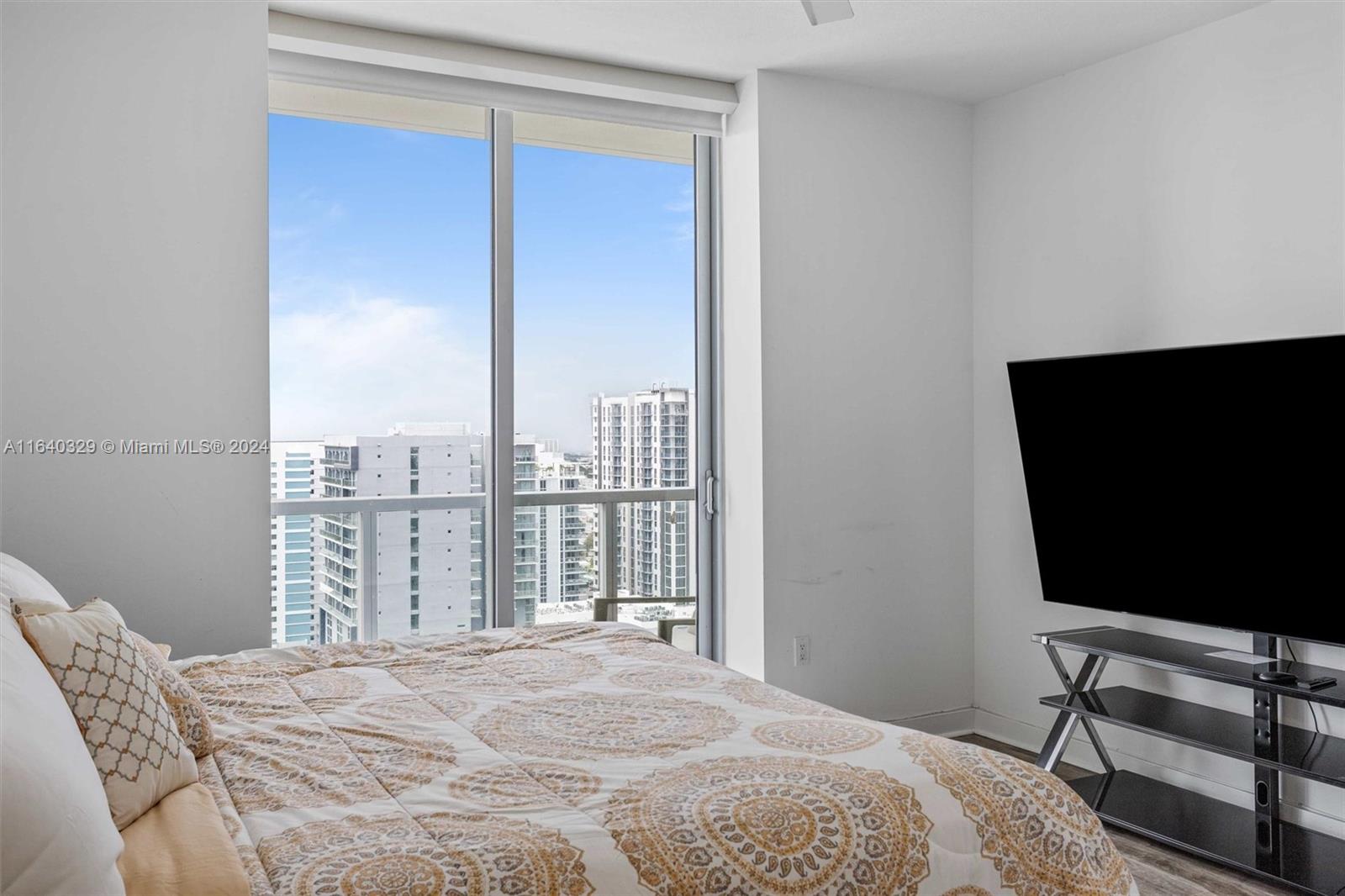 1111 Southwest 1st Avenue, Unit 3014N Miami, FL 33130 - Photo 10 of 36 a bedroom with a bed tv and a window