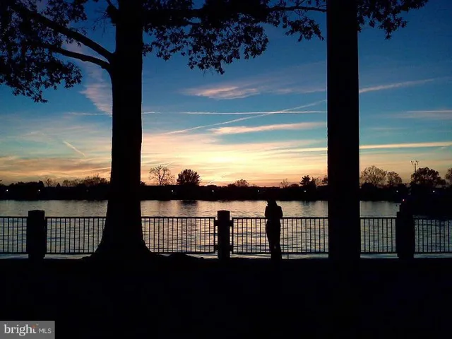 a front view of a house with swimming pool and sitting area