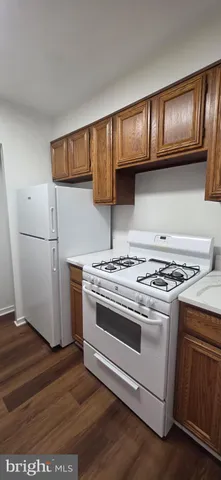 a stove top oven sitting inside of a kitchen