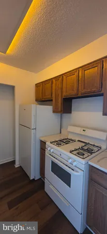 a kitchen with a stove and a refrigerator