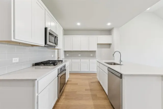 a kitchen with sink and refrigerator