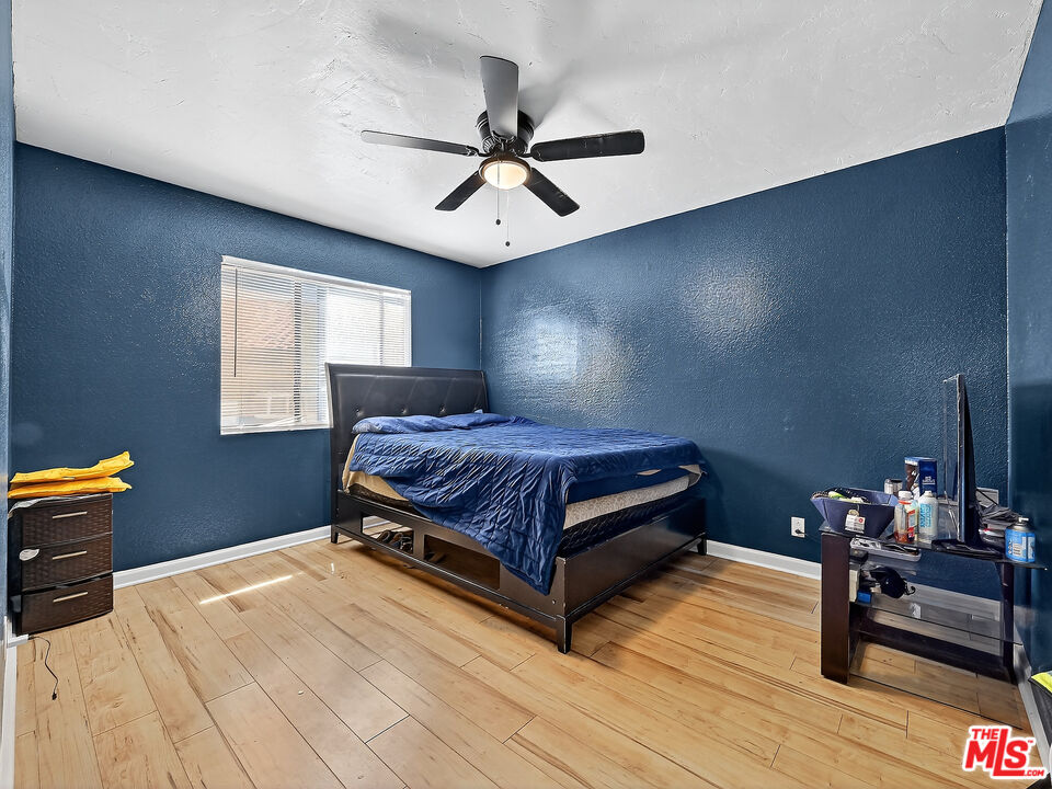 4159 Roxbury Drive Hemet, CA 92545 - Photo 20 of 28 a bedroom with a bed and wooden floor