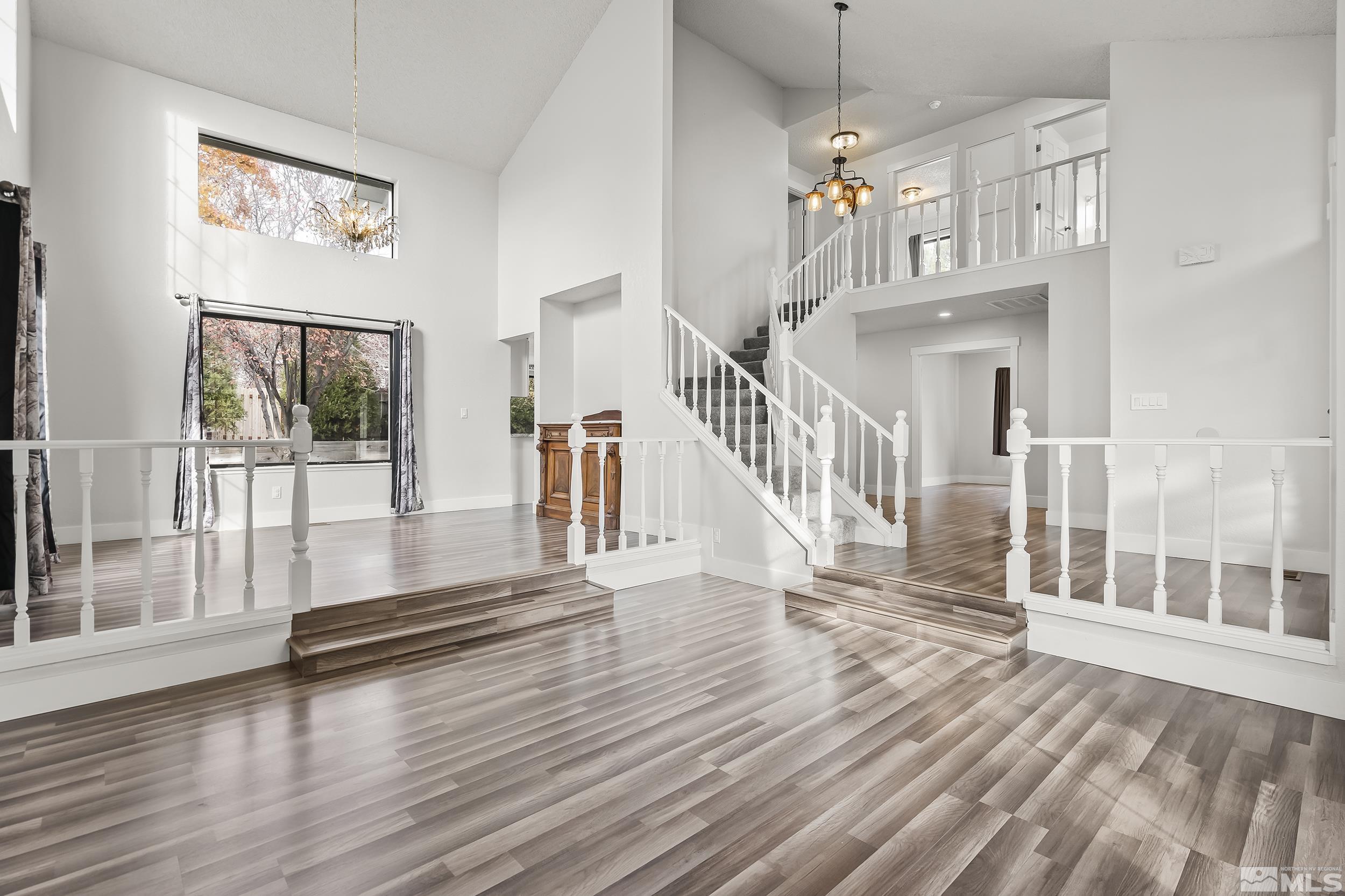 5651 West Rainbow Ridge Court Reno, NV 89523 - Photo 4 of 26 a view of a livingroom with wooden floor and stairs