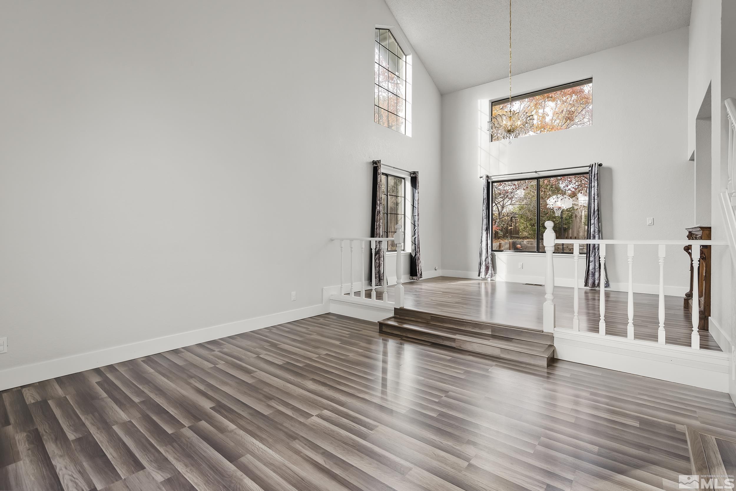 5651 West Rainbow Ridge Court Reno, NV 89523 - Photo 5 of 26 a view of empty room with wooden floor and fan