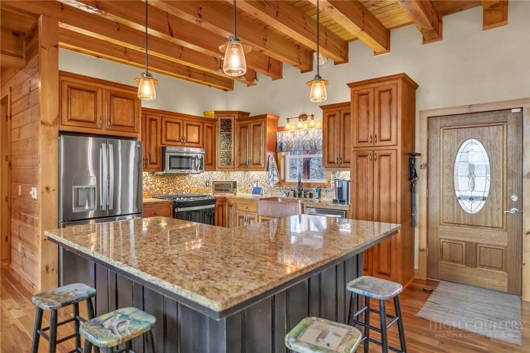 7994 3 Top Road Todd, NC 28684 - Photo 10 of 50 a kitchen with a table chairs and chandelier