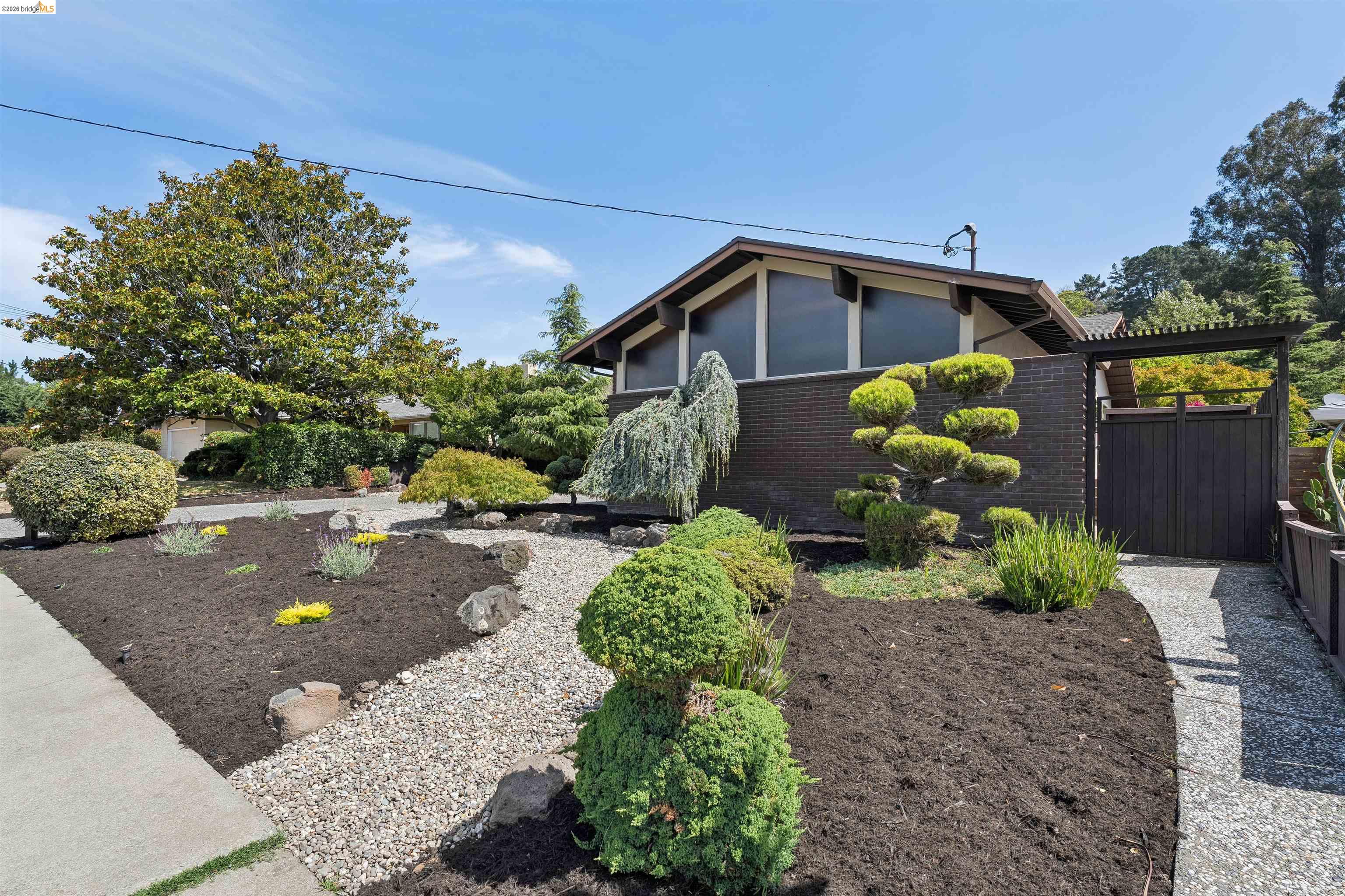 7 Jo Lin Court El Sobrante, CA 94803 - Photo 17 of 99 Mid-century modern exterior featuring a dark brick facade and a distinct low-pitched roofline