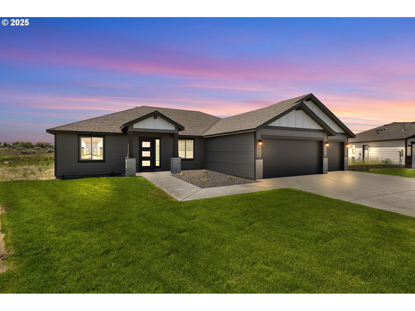 a front view of a house with a yard and garage