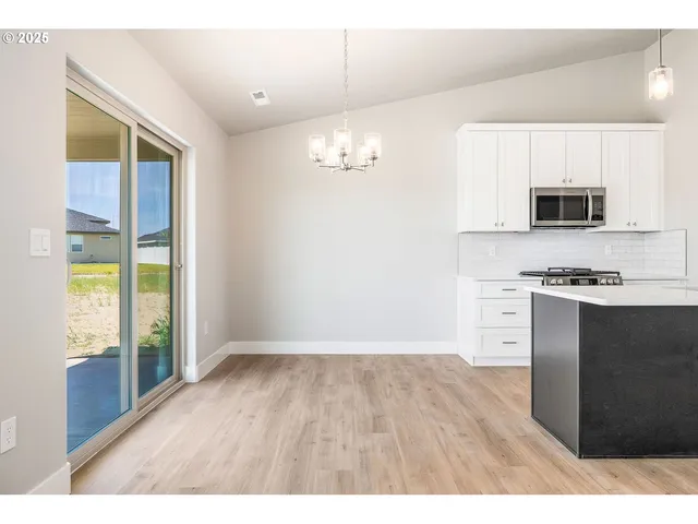 a kitchen with stainless steel appliances a refrigerator and a stove top oven