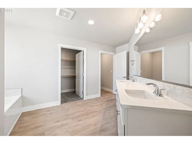 a bathroom with a sink a light fixture and a mirror