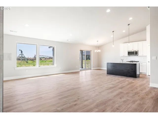 a view of a kitchen with a sink and a large window