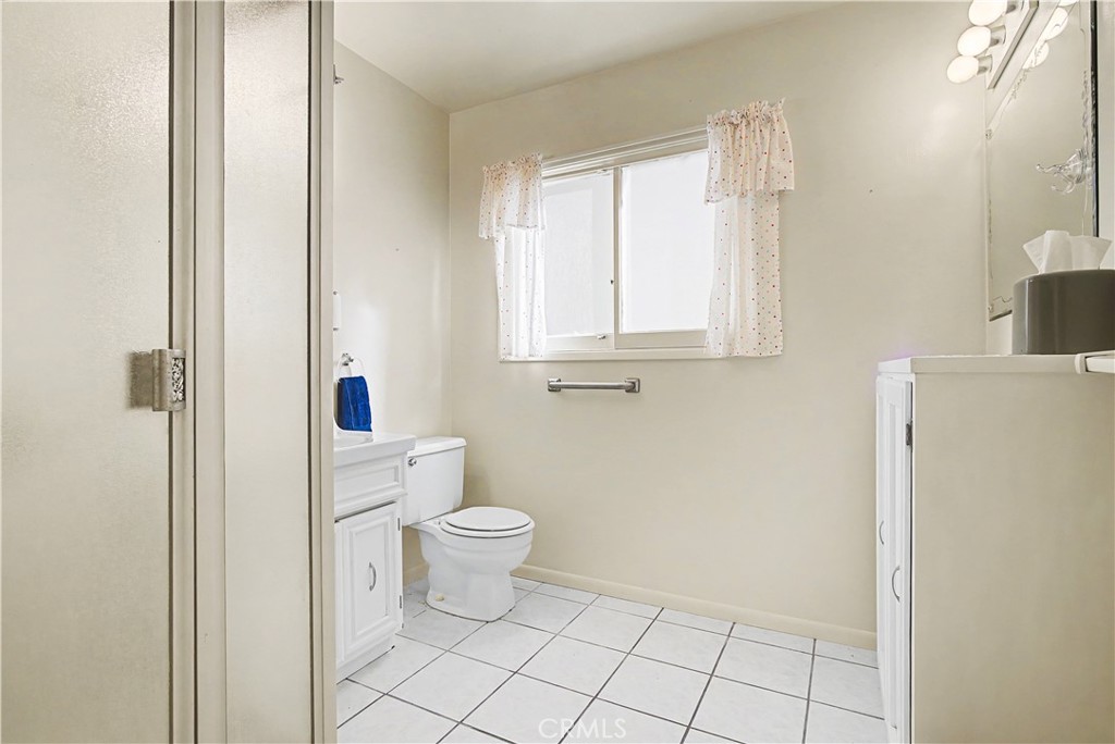 628 13th Street Manhattan Beach, CA 90266 - Photo 19 of 36 a white toilet sitting next to a bathroom sink and vanity