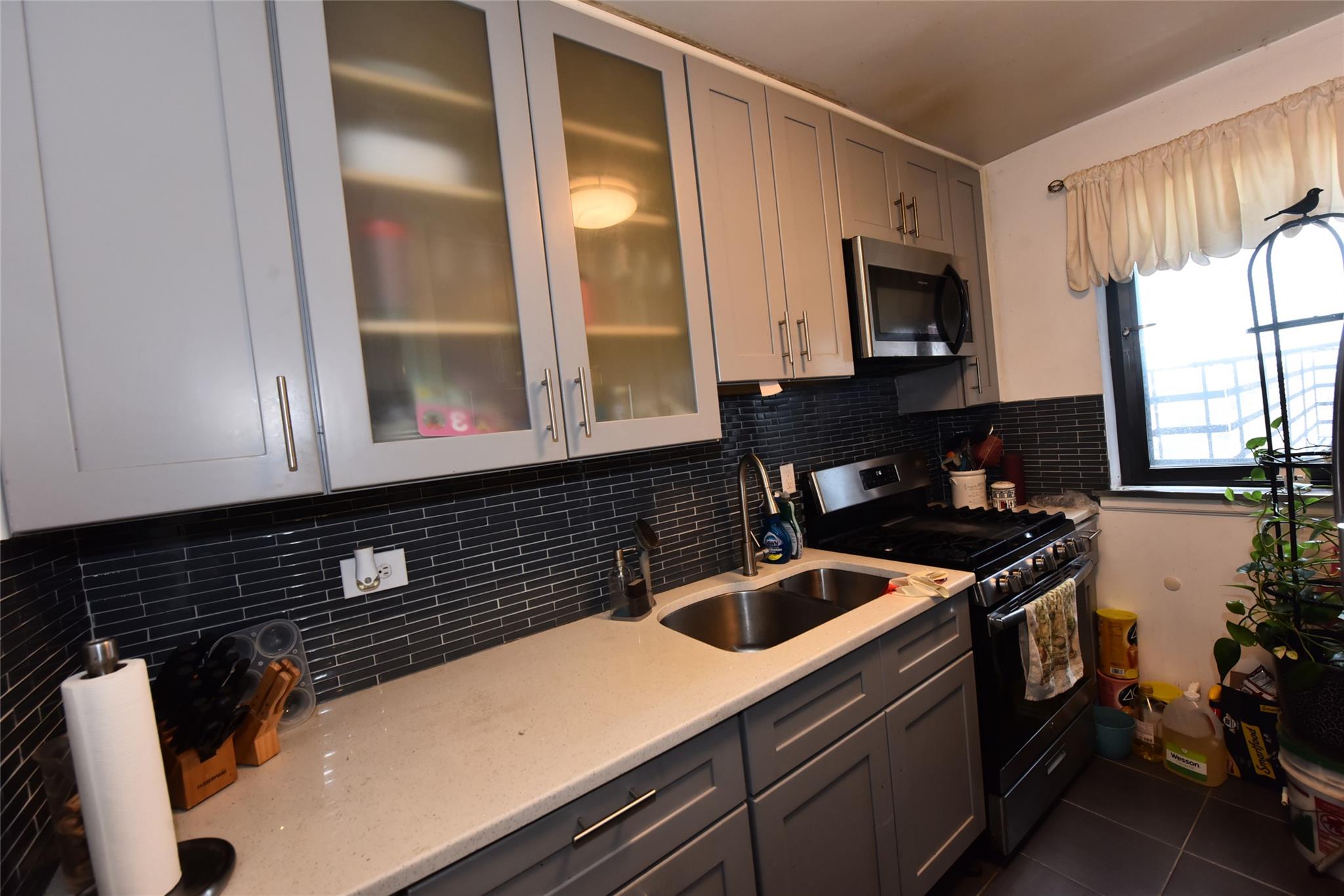 202-35 Foothill Avenue, Unit A78 Queens, NY 11423 - Photo 6 of 12 a kitchen with a sink and a stove top oven