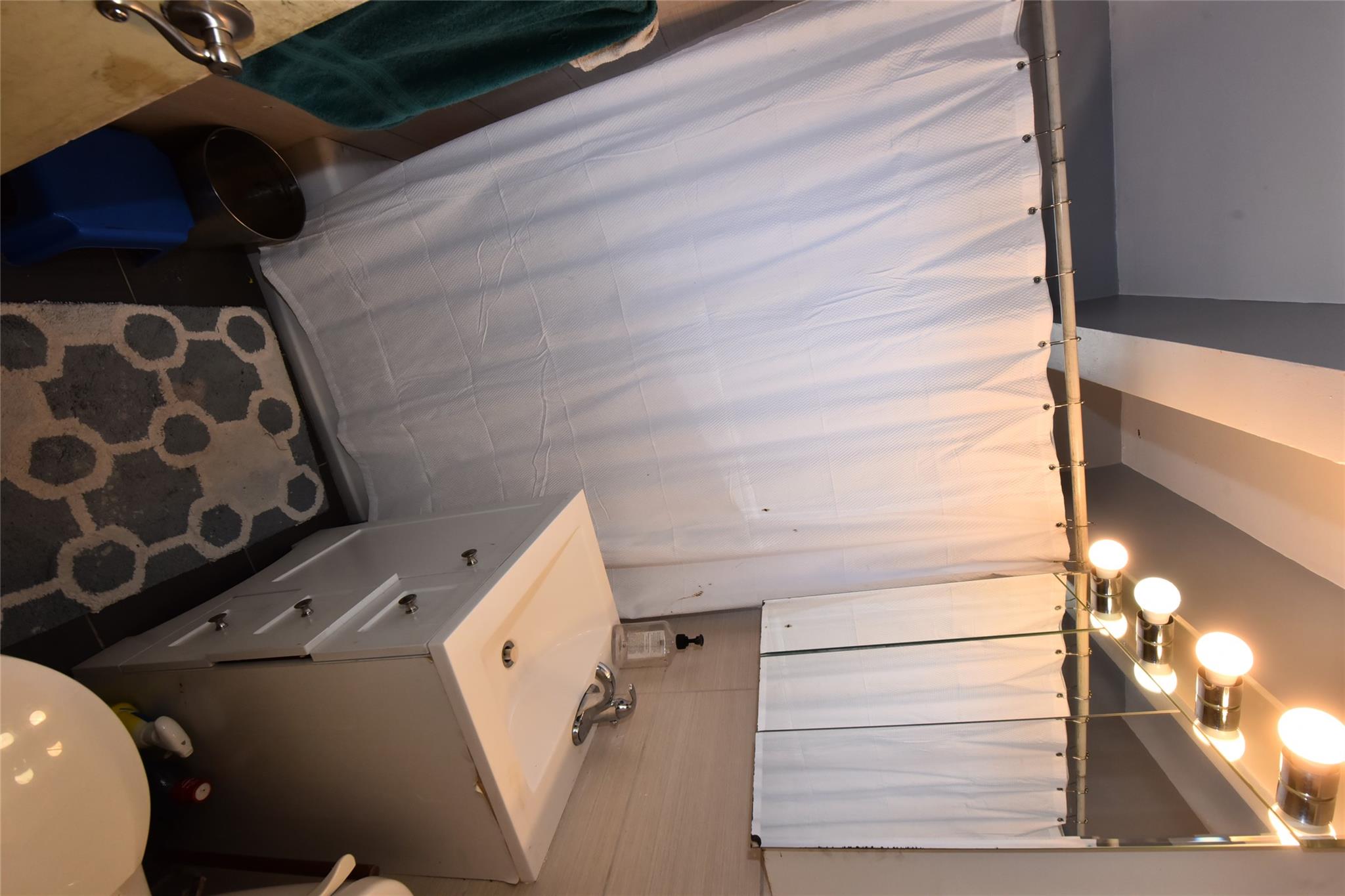 202-35 Foothill Avenue, Unit A78 Queens, NY 11423 - Photo 7 of 12 a bathroom with a sink and mirror